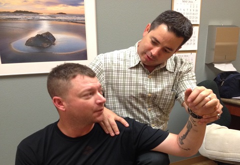 Dr. David Paris performs a chiropractic treatment for Veteran Adam Ingram at the Redding Outpatient Clinic in Northern California.