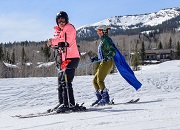 Mariela and a ski instructor race down Snowmass Mountain during the 2019 National Disabled Veterans Winter Sports Clinic.