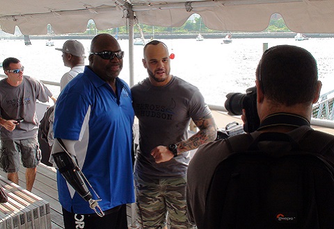 Chris Melendez, disabled Army Veteran, TNA Wrestling star and grand marshal of the 4th Annual Heroes on the Hudson event, at Pier 66 in Manhattan, greets a disabled Veteran.